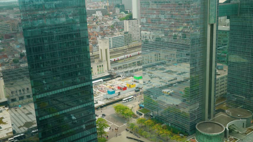 Brussels-North Station between high-rise offices in the Northern District, with railway tracks, trains and city skyline - Schaerbeek, Belgium