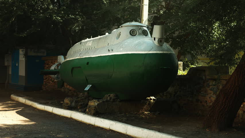 A green Soviet submarine stands in the middle of the street. Wartime era. World War III. The Soviet Union.