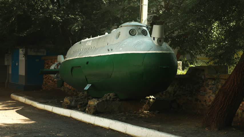 A green Soviet submarine stands in the middle of the street. Wartime era. World War III. The Soviet Union.