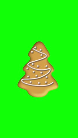 3D animated vertical Christmas tree gingerbread cookie with white icing on chroma key green screen background for mobile video overlay