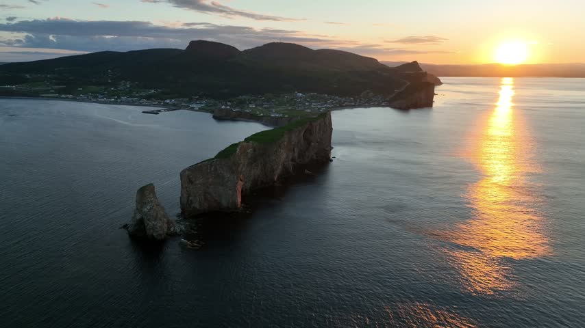 Stunning sunset drone views of Perce rock Gaspe Peninsula Quebec Canada