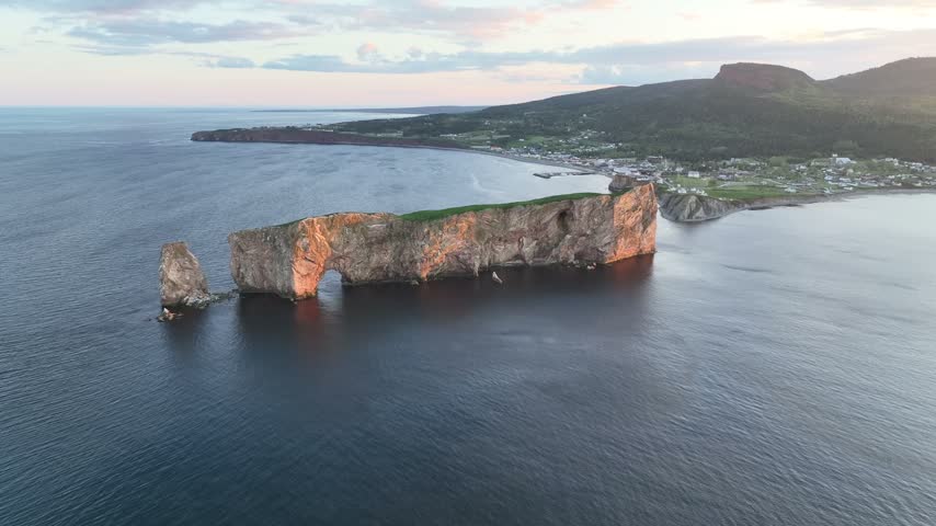 Stunning sunset drone views of Perce rock Gaspe Peninsula Quebec Canada
