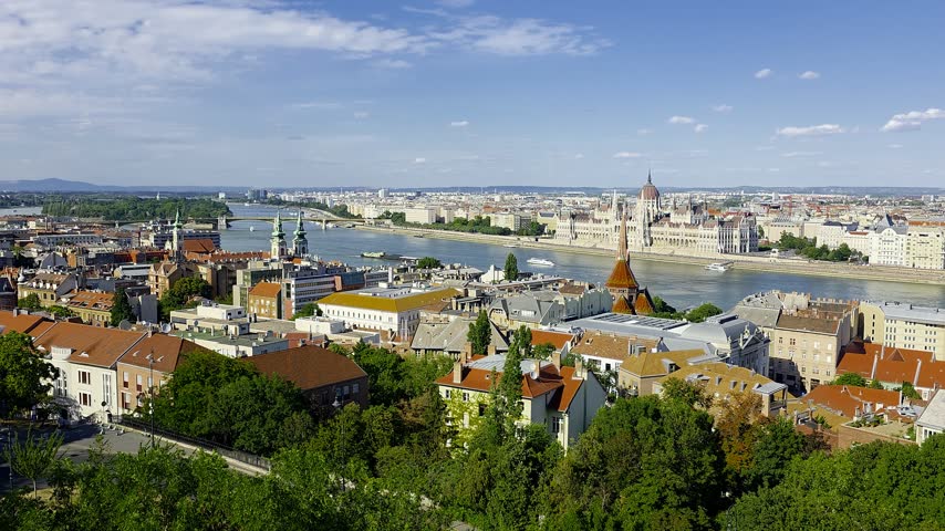Panoramic daytime view of the Budapest cityscape in Hungary, featuring the Danube river, historic bridges, and classic European architecture. Majestic urban skyline and cultural heritage
