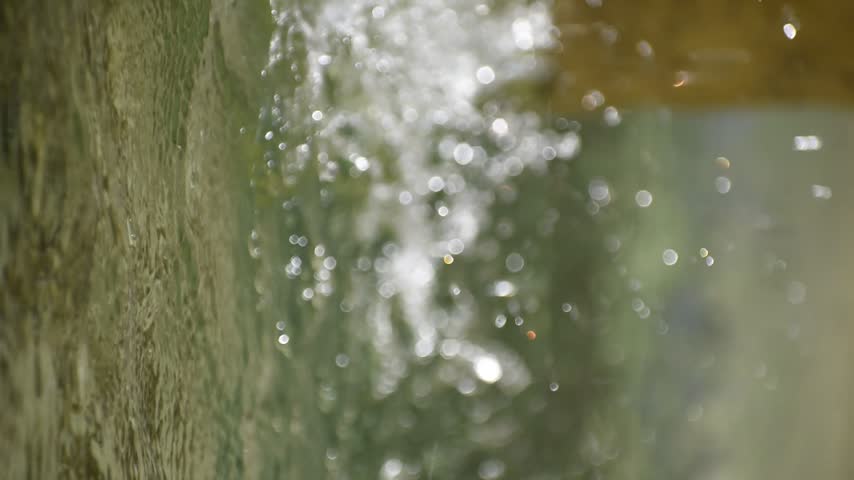 A dreamy view of water flowing through the surface of the pond.