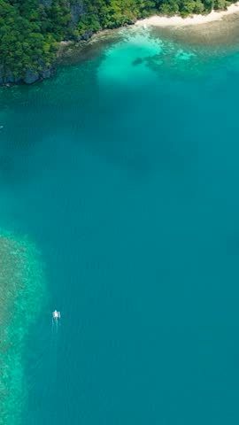 Pasandigan Cove with turquoise water and white sand beaches. Cadlao Island. El Nido. Palawan, Philippines. Vertical view.