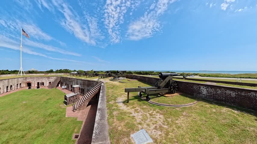 leftward panorama moves from a foreground cannon toward Fort Macon courtyard.