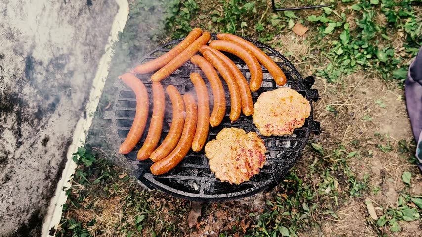 Barbeque in backyard, barbeque burger and sausage outdoor close up