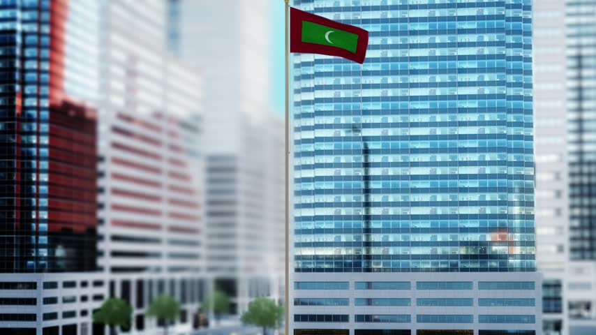 Maldives Flag Waving by Modern Glass Buildings - Daytime