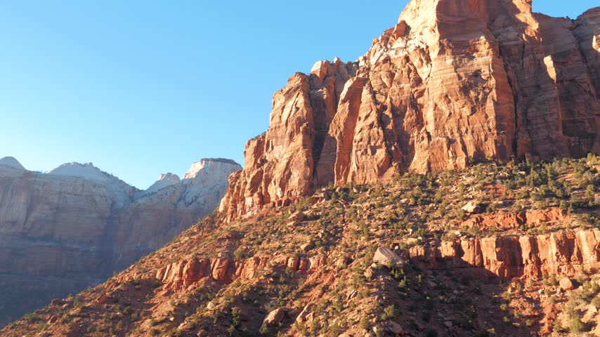 Picturesque red rock formations of zion national park in utah seen from moving vehicle during scenic drive at sunrise, revealing canyon majestic and layered landscape