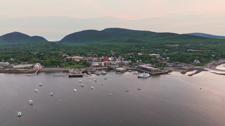 Aerial view of the Bar Harbor waterfront, pier and moored boats in Frenchman Bay at dusk, Mount Desert Island, Maine, USA.