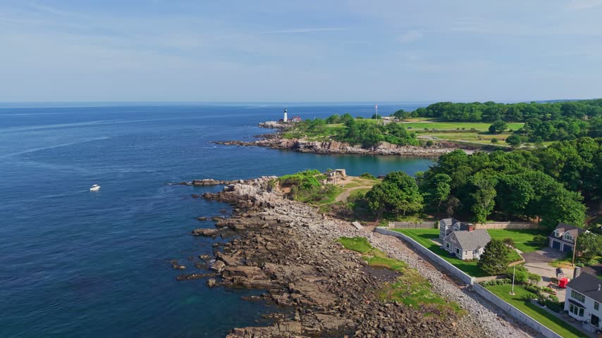 Aerial view of the rugged coastline and lighthouse at Fort Williams Park in Cape Elizabeth near Portland, Maine, USA.