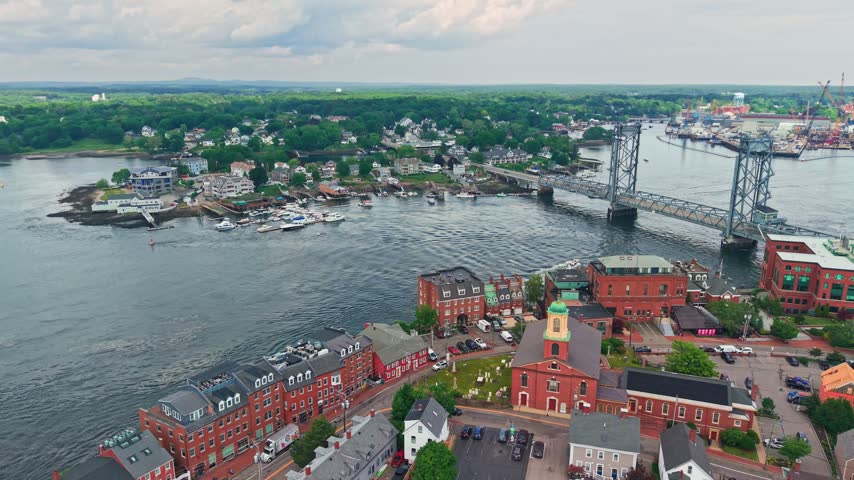Aerial view of downtown Portsmouth, New Hampshire, its historic brick buildings and the Memorial Bridge over the Piscataqua River, USA.