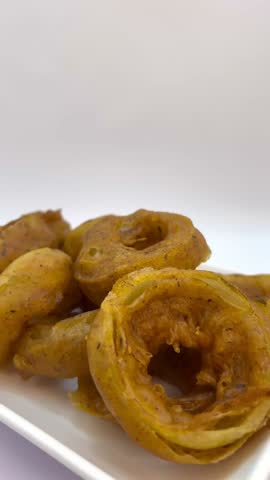 Crispy Fried Battered Rings with Creamy Dipping Sauce on White Plate