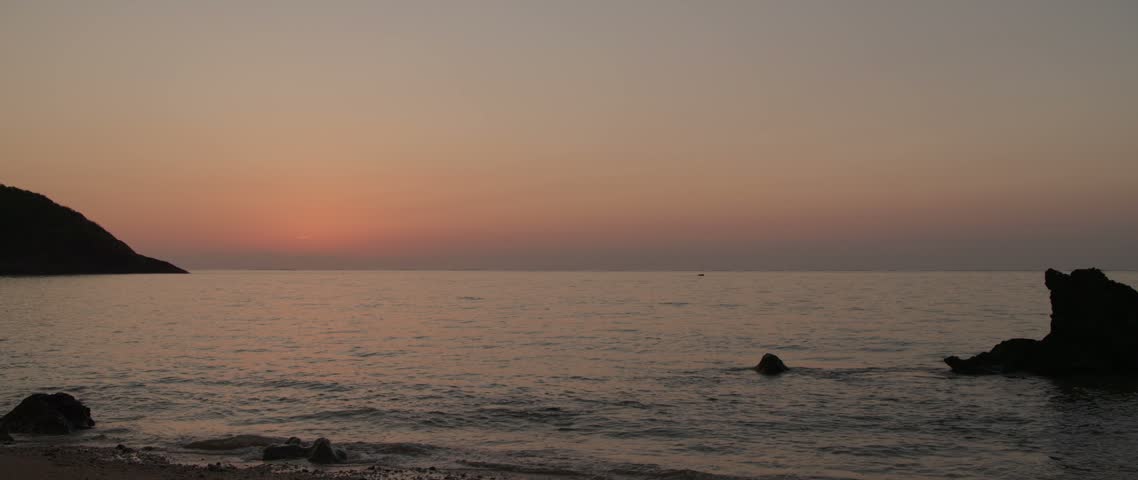 Sun rising over the horizon from the coast of Ishigaki Island