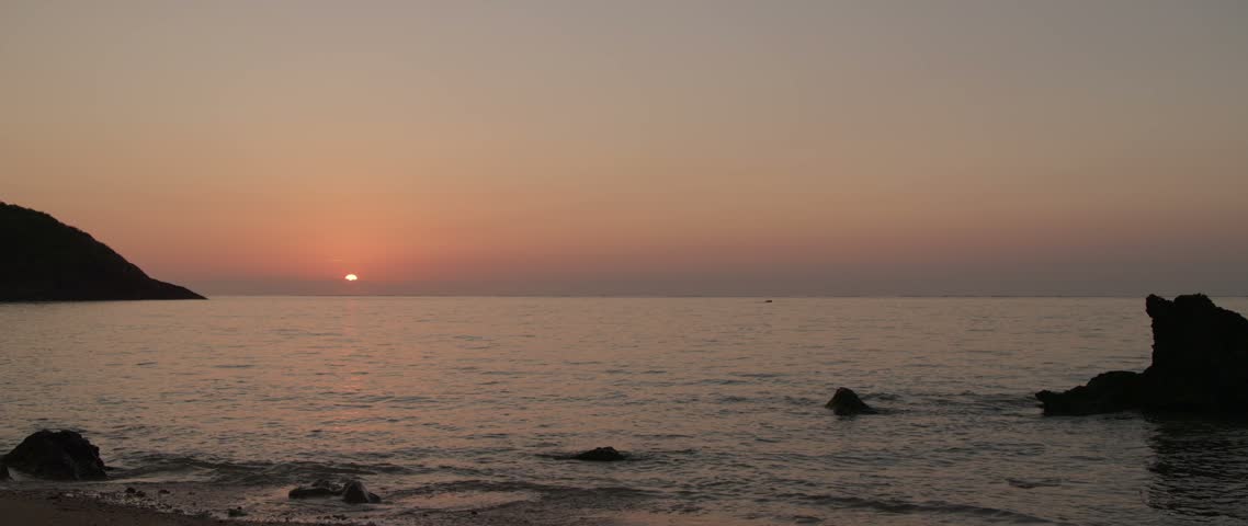 Sun rising over the horizon from the coast of Ishigaki Island