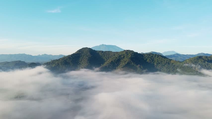 Aerial view of mountain peak above sea of clouds