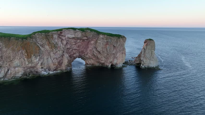 Scenic drone sunset views of Perce rock Gaspe Peninsula Quebec Canada