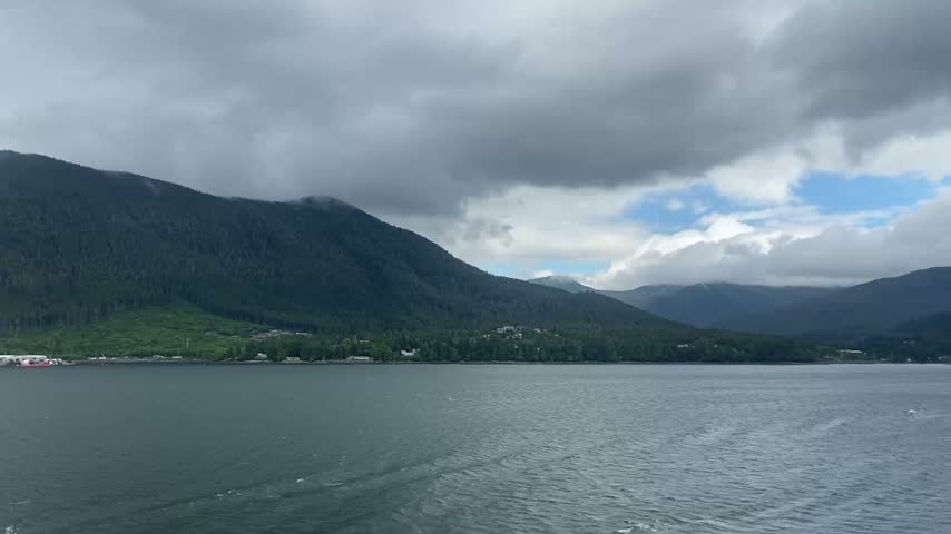Stunning mountain scenery over Alaskan waters under cloudy sky,Stunning mountain fjord under cloudy sky
