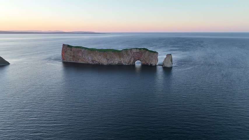 Scenic aerial sunset drone views of Perce rock Gaspe Peninsula Quebec Canada