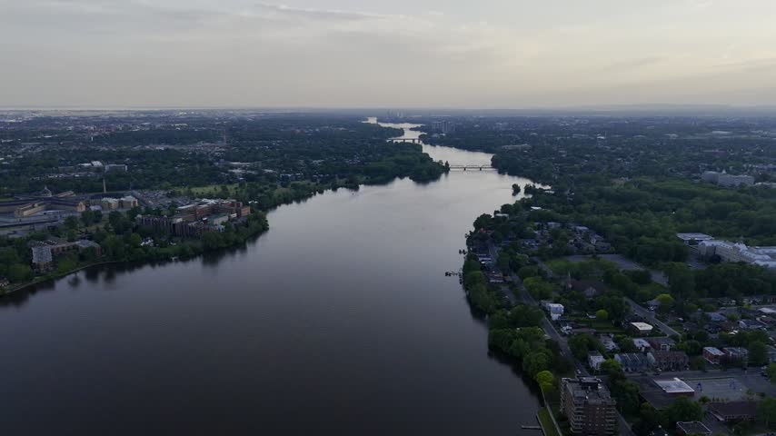Aerial panoramic view of the Riviere des Prairies between Montreal and Laval, Quebec, Canada at sunset. g.