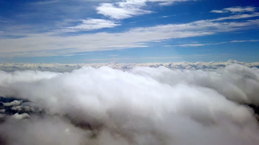 Airplane Window View Flying above a sea of clouds over Gran Canaria, Spain