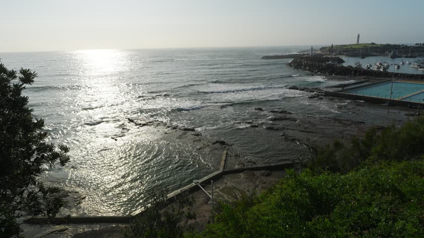 Morning sun glitters on the ocean beside Wollongong