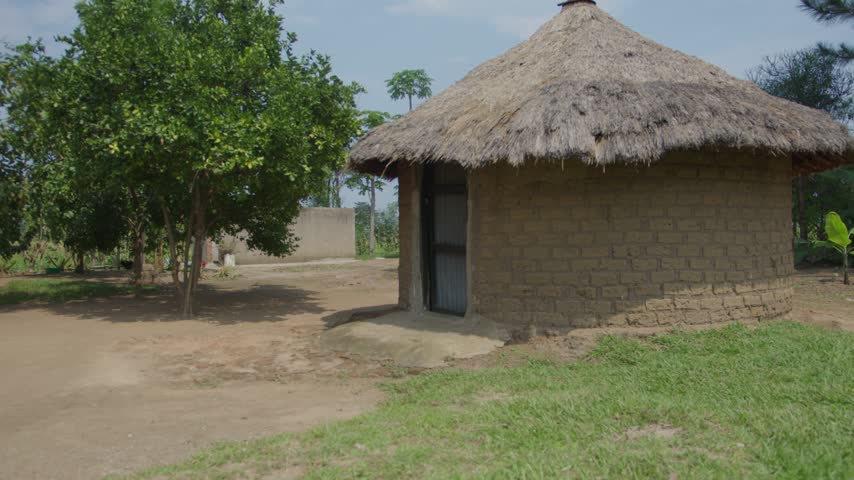 Traditional African Homestead in Village with Smoke in the Background of a Mud Hut