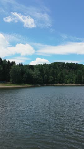 Beautiful Lake Landscape with Forest, Blue Sky, and Reflections