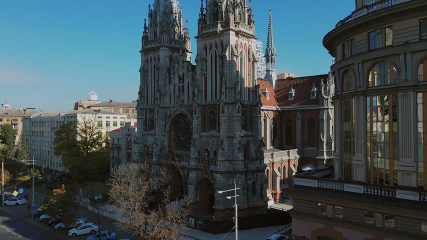 Gothic St Nicholas Roman Catholic Church stands along city street in Kyiv
