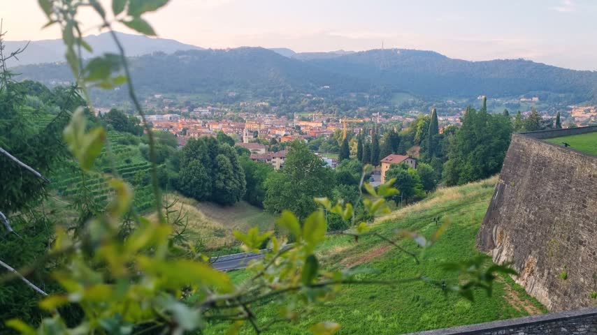 View over Bergamo, Lombardy, Italy, from the historic Venetian Walls of Città Alta, overlooking the city and surrounding green landscape in fresh spring scenery