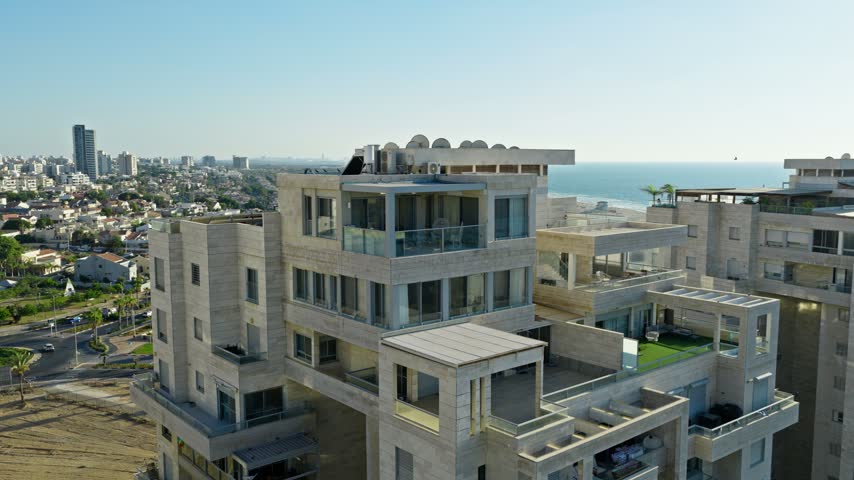 Aerial drone view over modern luxury residential buildings and penthouses near Ashdod Marina with the Mediterranean Sea and beach shoreline in the background Israel.