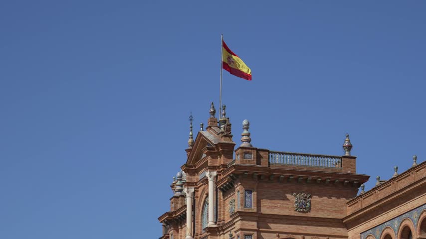 Scenic view of Plaza de Espana architectural landmark square and flag in Seville, Spain