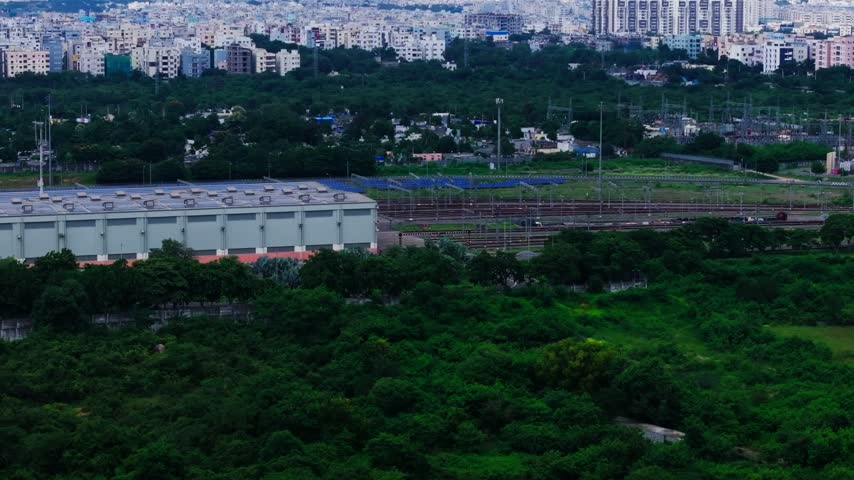 Miyapur Metro rail depot with surrounding greenery and Residential Buildings at hyderabad, telangana, india. day time, arc shot, drone shot, 4k.