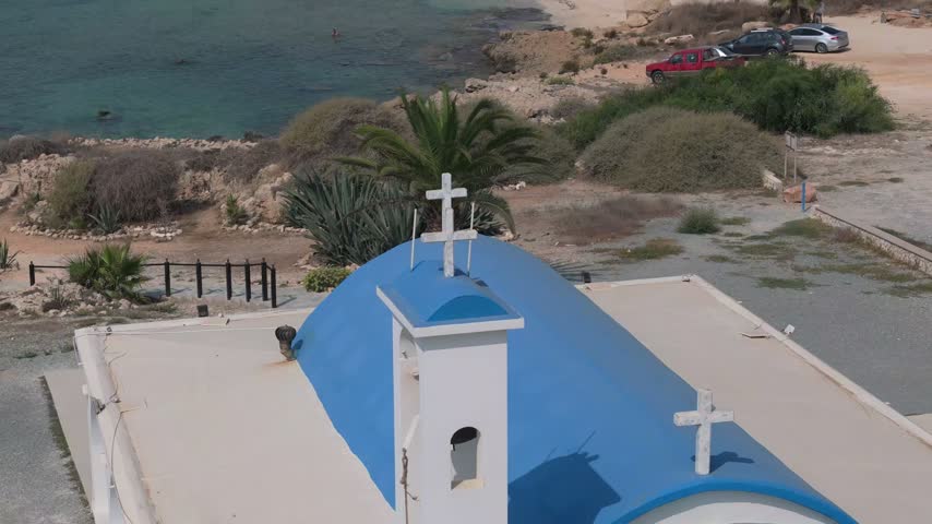 Aerial view of a small chapel with a blue roof located near the coastline in Famagusta, Famagusta, Northern Cyprus.