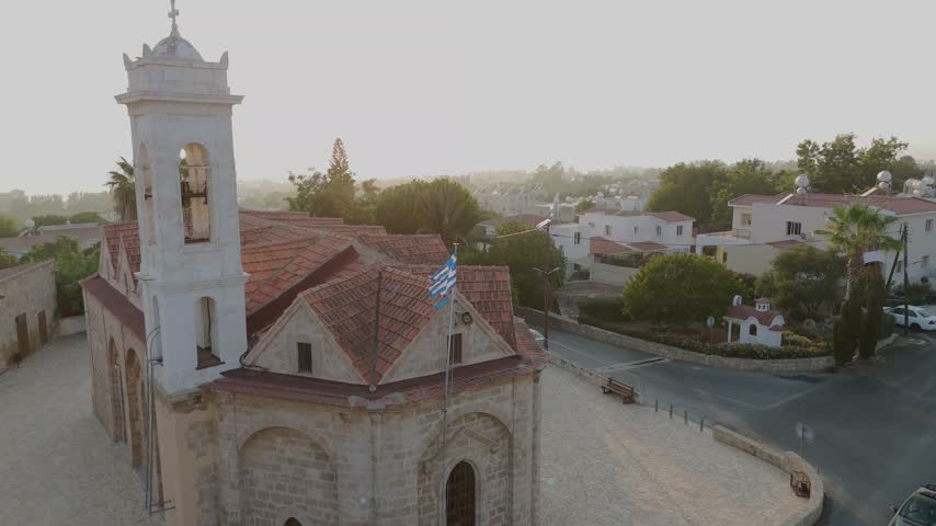 Aerial view of a historic stone church with a bell tower and red tiled roof in Nicosia, Nicosia, Cyprus.