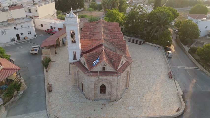 Aerial view of a historic stone church with a red tiled roof and bell tower situated in a cobblestone courtyard in Nicosia, Nicosia, Cyprus.