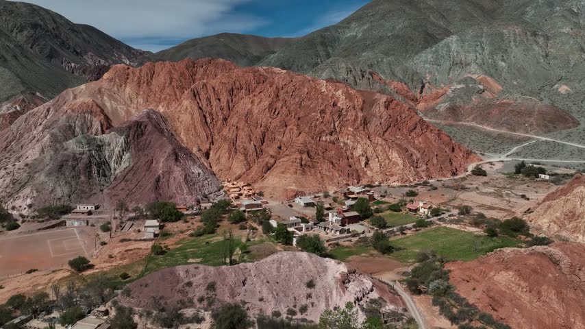 Aerial view of a soccer field at the foot of Cerro de los Siete Colores mountain in Purmamarca, Jujuy, Argentina