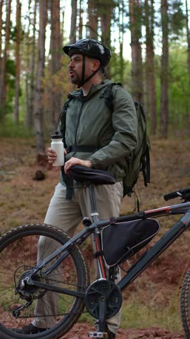 Exploring nature on a mountain bike while enjoying a refreshing drink