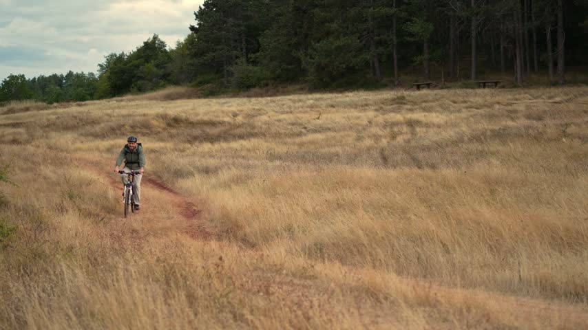 Exploring nature trails on a mountain bike through golden grasslands