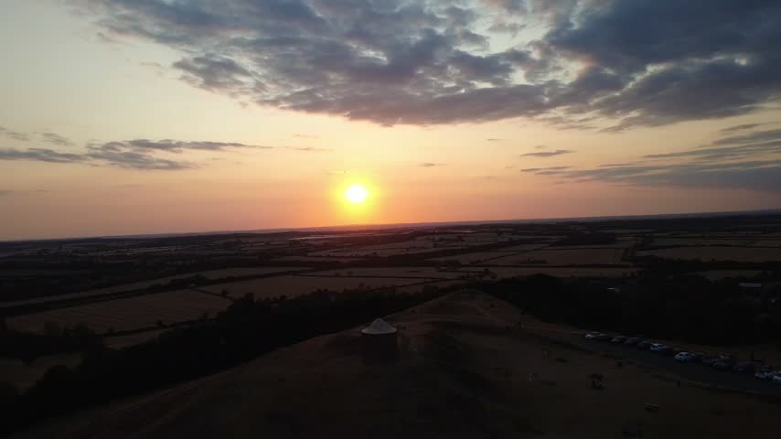 Scenic aerial footage of the countryside surrounding Burton Dassett Hill, captured during sunset with warm golden tones across the landscape.