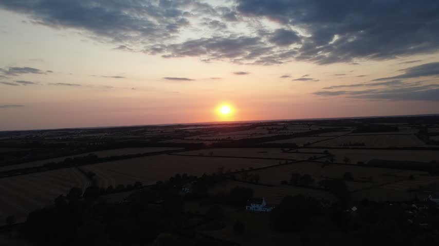 Wide sunset views from above Burton Dassett Hill, revealing open fields, rolling hills and the surrounding Warwickshire countryside.