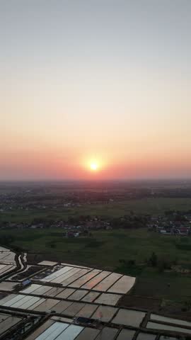  Aerial View of a Serene Sunset Over Agricultural Farmlands and Rural Landscapes