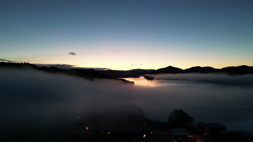 Serene Nordic Fjord Landscape with Floating Fog and Calm Water at Dusk