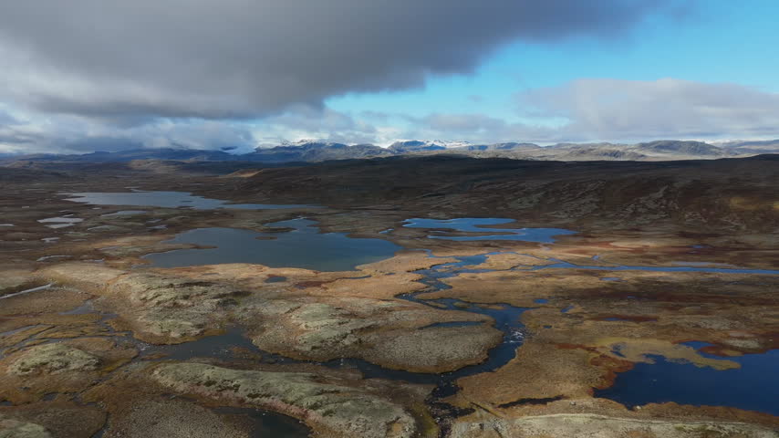 Hardangervidda, Norway. Marsh landscape, aerial view over mountains and clouds. Autumn. 