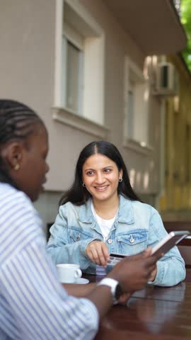 Multiracial women enjoying online shopping with tablet