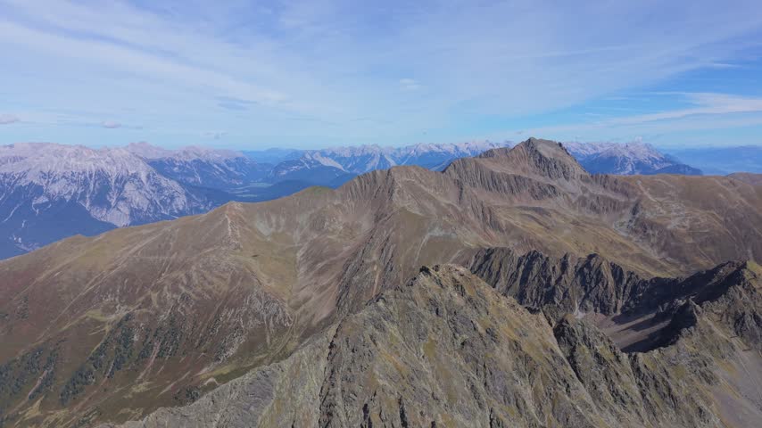 Slow drone flight above rugged mountain slopes in Tyrol, Austria