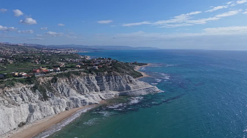 Aerial view of the white marl cliffs of Stair of the Turks along the Mediterranean coastline in Realmonte, Sicily, Italy.
