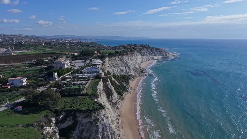 Aerial view of the white marl cliffs of the Stair of the Turks meeting the Mediterranean sea along the coastline of Realmonte, Sicily, Italy.