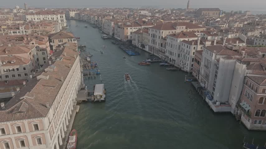 Aerial view of the Grand Canal with historic buildings and boats navigating the waterway in Venice, Veneto, Italy.