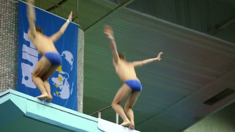 MOSCOW - APR 13: Male twofold jump during competitions on syncronized diving in pool of Sport Complex Olympic on day of third phase of World Series of FINA Diving, April 13, 2012, Moscow, Russia.